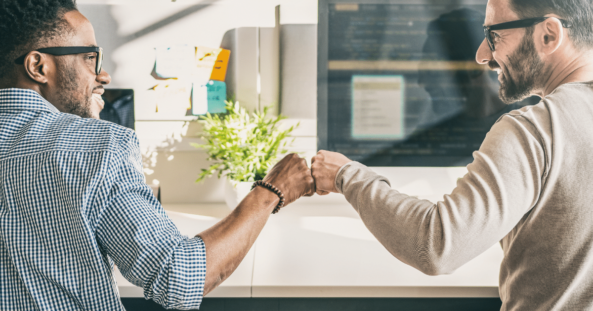 coworkers fist bumping because online conversions boosted