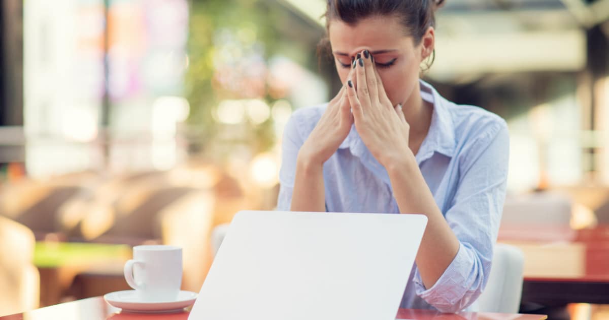 female frustrated at laptop because mqls aren't converting to pipeline