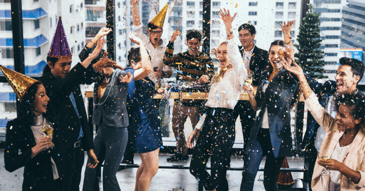 group in office celebrating and throwing confetti