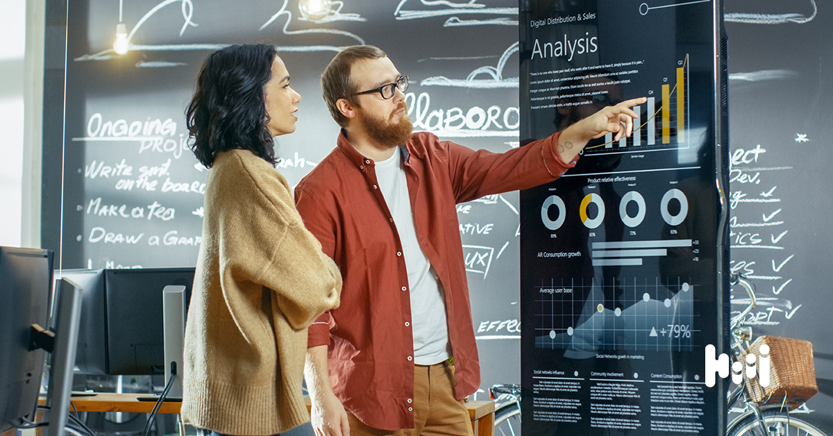 A marketing duo discussing display advertising advantages and disadvantages displayed on a screen.