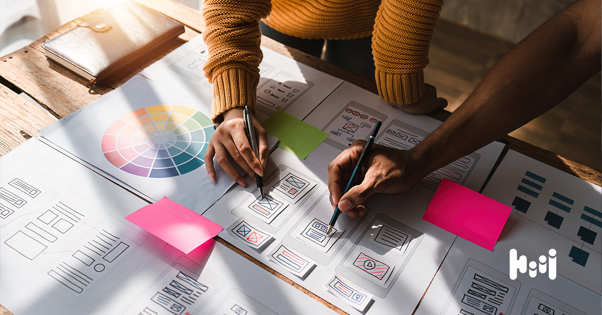 A marketing duo discussing some notes over their display ad design.